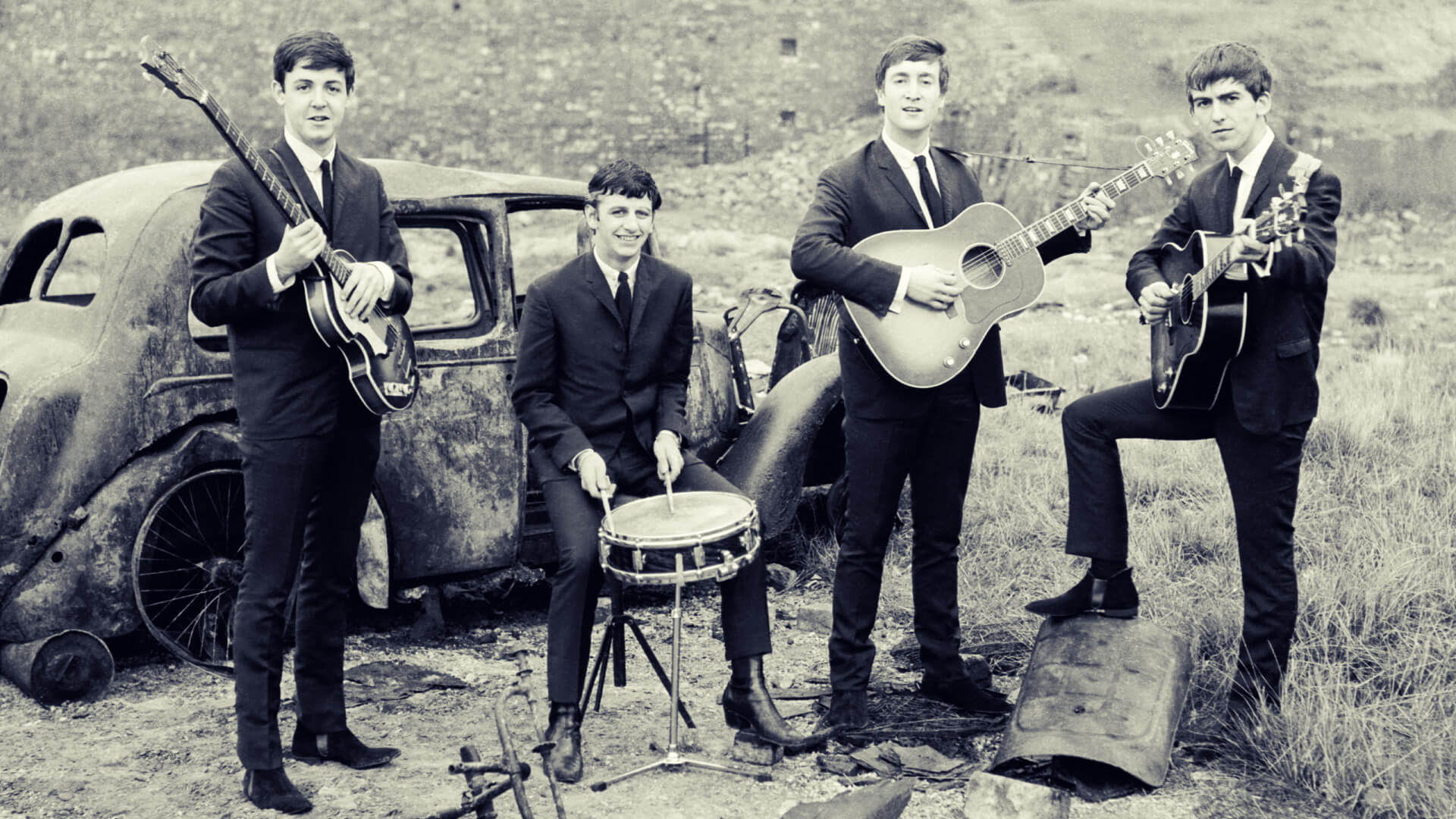 A group of people in suits and ties playing instruments.